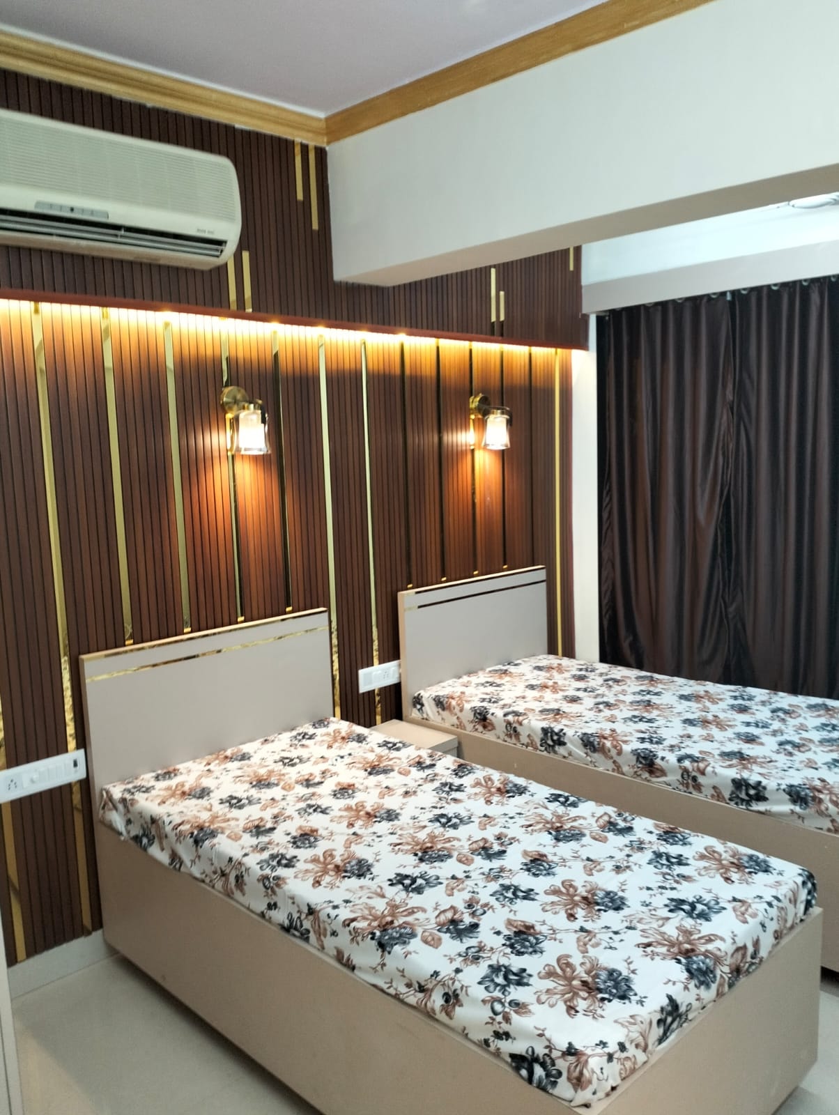 Bedroom with gold accent lighting at The Aura