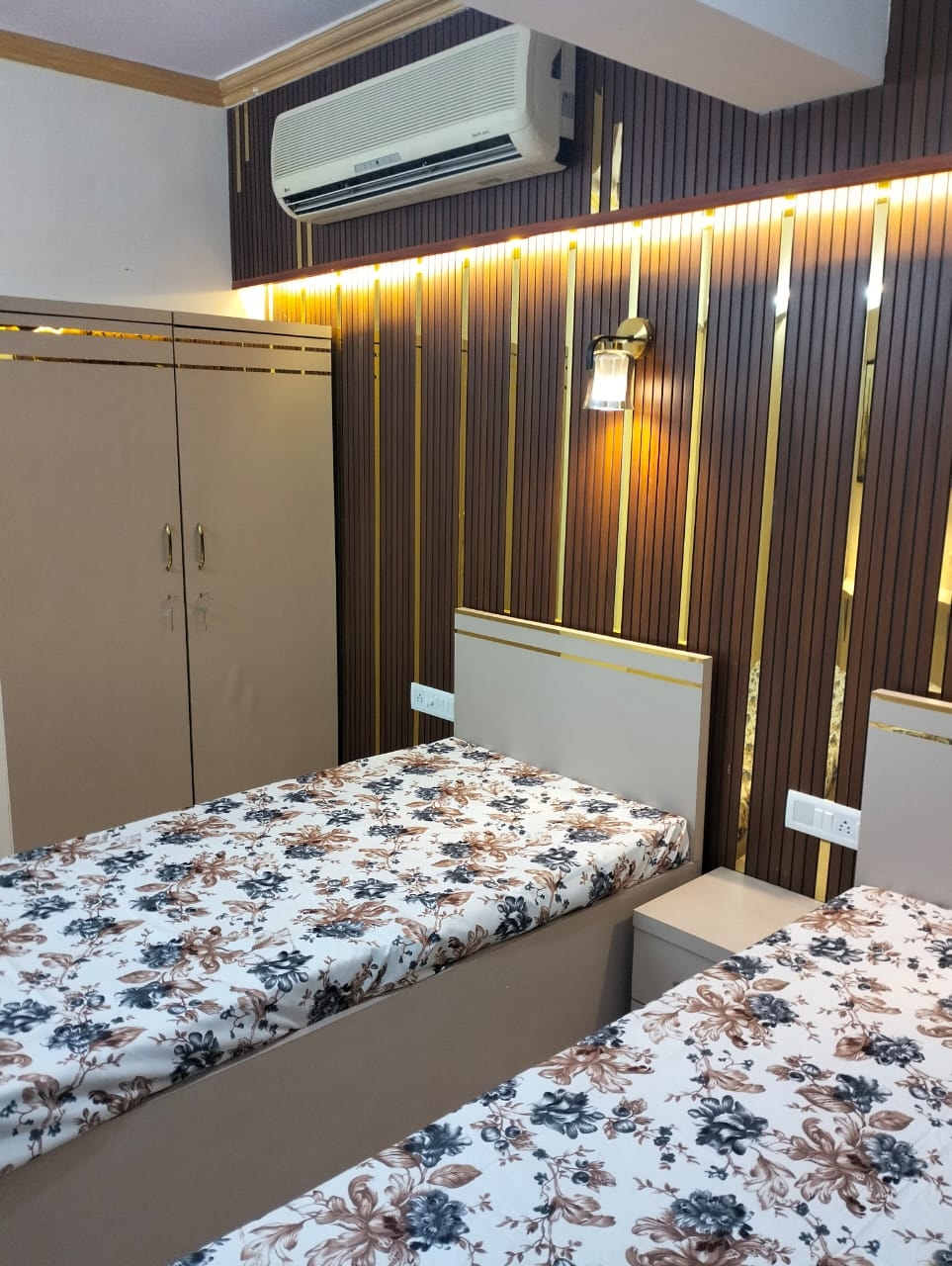 Furnished room with dark wood paneling at The Aura