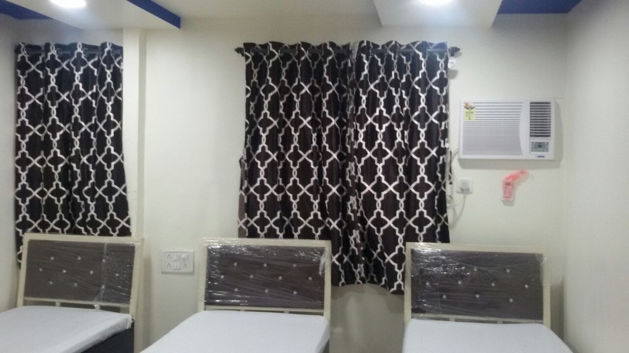 Bedroom with geometric curtains at The Aura
